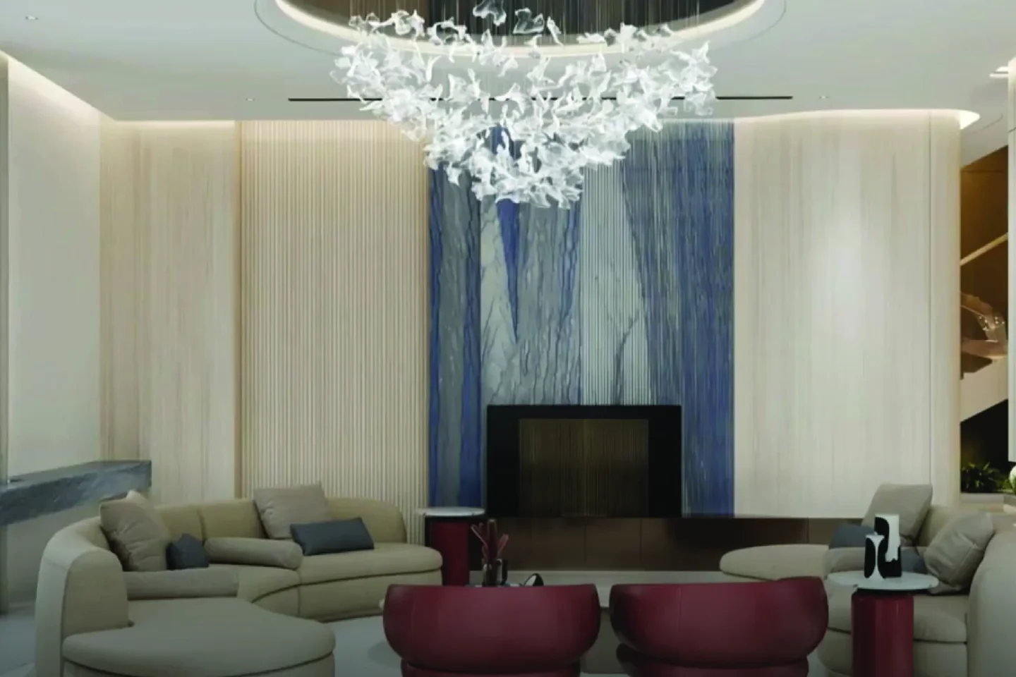 KH Villa living room with chandelier and red accent chairs